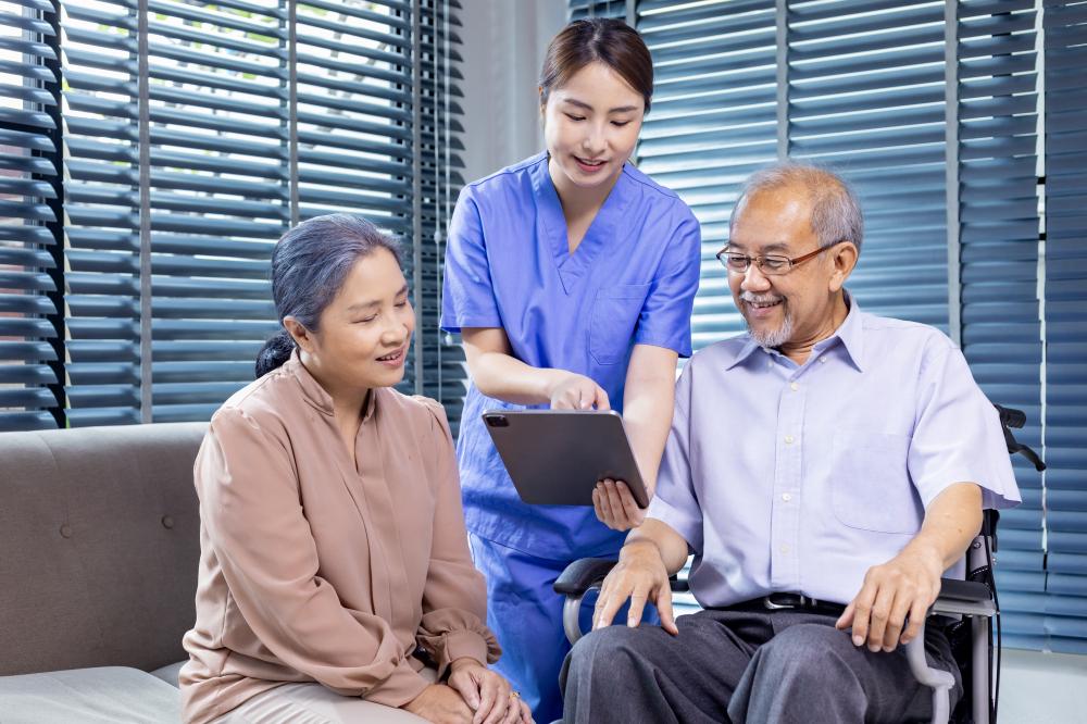 Senior couple receiving care from home health aide in NYC