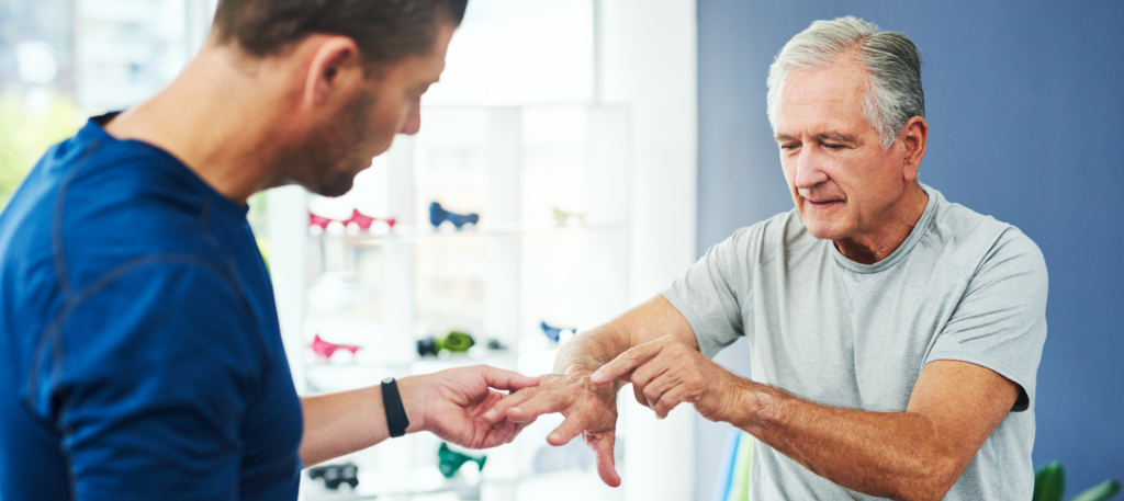 Senior showing doctor his hand